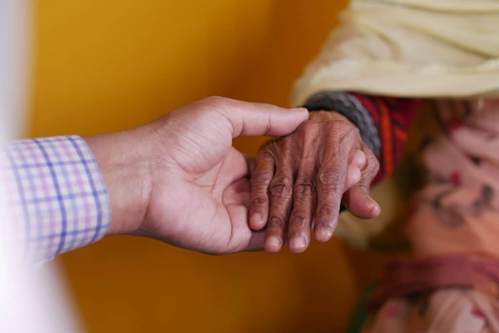 doctor holding hand of a senior women